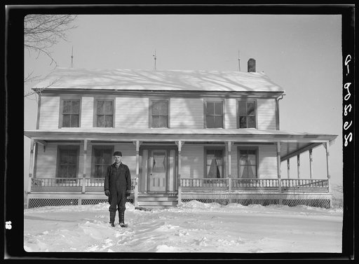 William Wallace, resettled farmer in front of his new home. Oswego County, New York