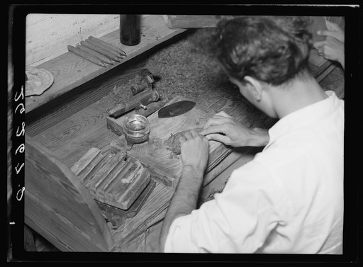 Cigar workers, stranded when factories moved north, turn to manufacturing in their homes. Key West, Florida
