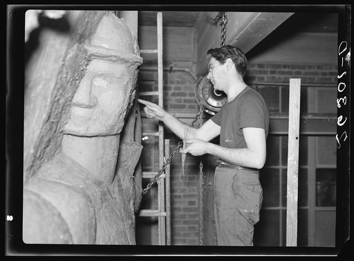 Washington, D.C. Vernon Atchely working at the Special Skills project of the Farm Security Administration on a relief figure for the Greendale school