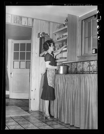 Wife of part-time farmer in kitchen of her home at Loogootee. Wabash Farms, Indiana