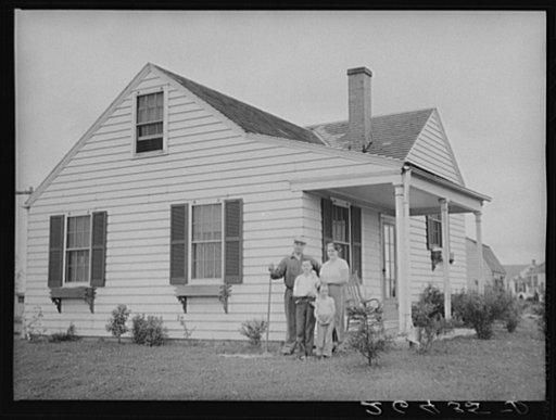The Bollinger family in front of their home. Decatur Homesteads, Indiana