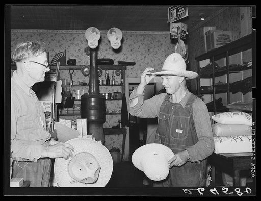 Farmer buying a new hat in the store at Blankenship, Indiana