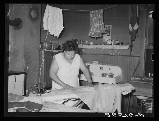 Steel worker's wife ironing clothes. Midland, Pennsylvania