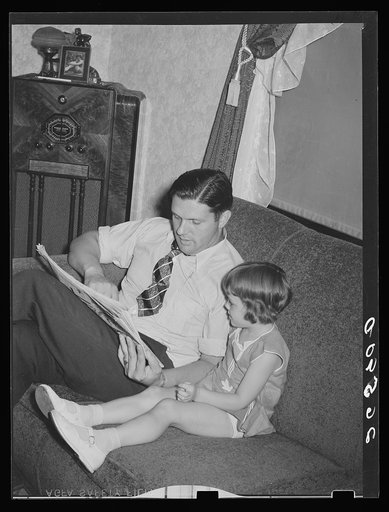 Clifford Shorts reading the funnies to his daughter. Aliquippa, Pennsylvania