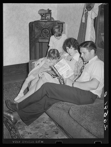 Clifford Shorts and family reading about homes for workers. Aliquippa, Pennsylvania