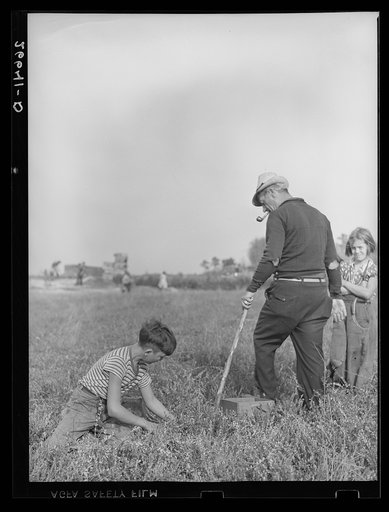 The padrone (labor contractor), who also acts as foreman in the bogs, directing a boy picking cranberries. Burlington County, New Jersey