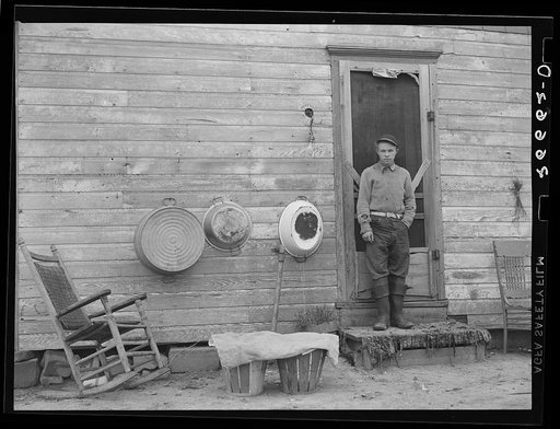 Son of agricultural worker on steps of his home. Burlington County, New Jersey