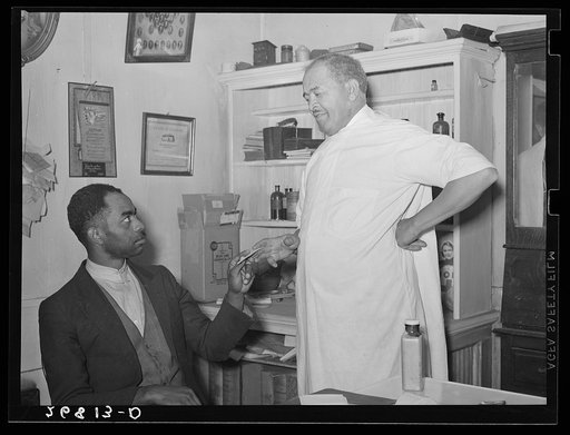 Dr. Springs giving prescription to patient. Colp, Illinois