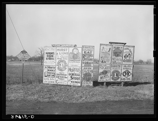 Signs along highway approaching Hurst, Illinois. Williamson County, Illinois