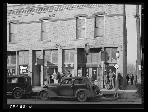 Unemployed miners on street corner. Johnston City, Illinois