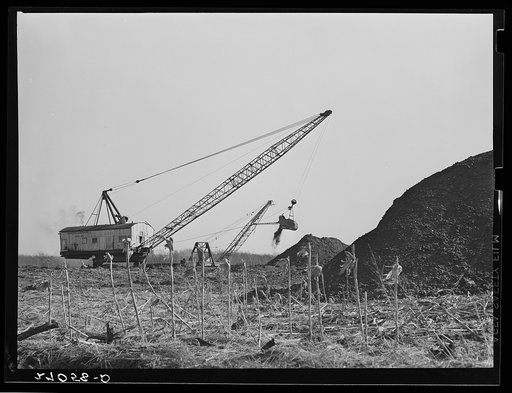 Strip coal mine encroaching upon farmland. Carterville, Illinois