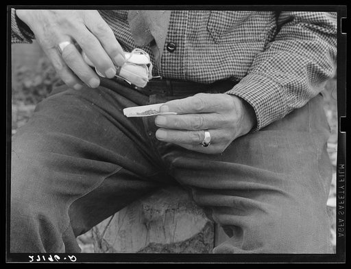 Cowpuncher making a cigarette. Bozeman, Montana