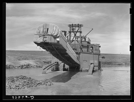 Dredge used in placer gold mining. Madison County, Montana