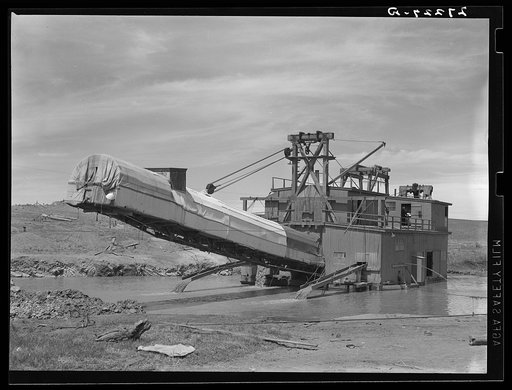 Dredge used in placer gold mining. Madison County, Montana