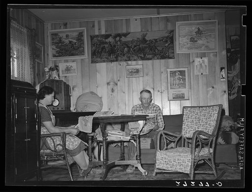 Farmer and wife in living room of new farmhouse. Fairfield Bench Farms, Montana