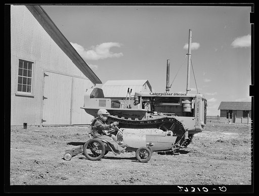 Untitled photo, possibly related to: Wheat farmer's son playing with tractor. Cascade County, Montana