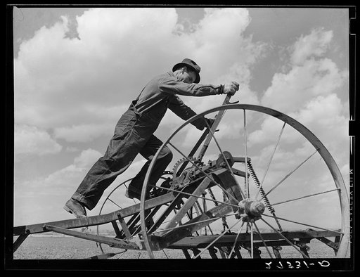 Farmer adjusting cultivator. Fairfield Bench Farms, Montana