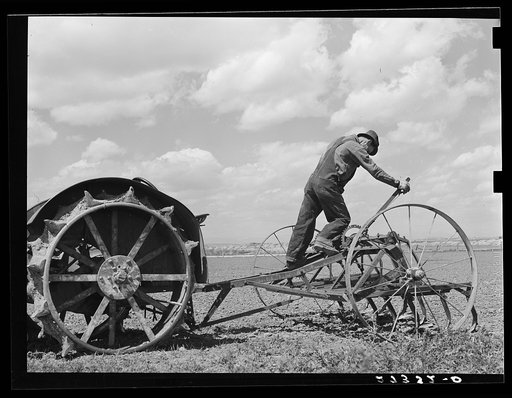 Untitled photo, possibly related to: Farmer adjusting cultivator. Fairfield Bench Farms, Montana