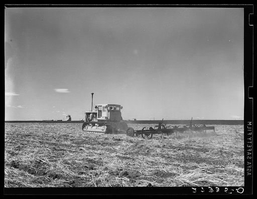 Tractor pulling a noble blade along a fallow strip on Henry Sheffels' farm. Cascade County, Montana