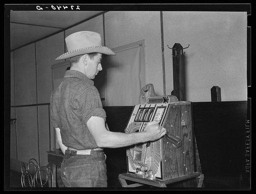 Dude playing a slot machine. Birney, Montana