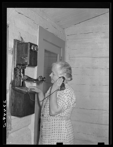 Wife of ranch owner on party line phone. Quarter Circle 'U' Ranch, Montana