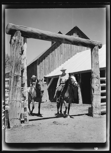 Dudes riding through corral gate. Quarter Circle 'U' Ranch, Montana