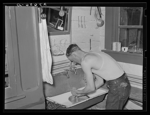 Cowhand washing for dinner. Quarter Circle 'U' Ranch, Montana