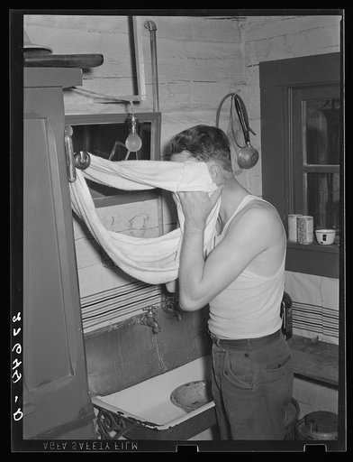 Cowhand using roller towel. Quarter Circle 'U' Ranch, Montana