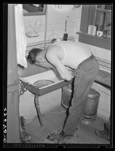 Cowhand washing for dinner. Quarter Circle 'U' Ranch, Montana