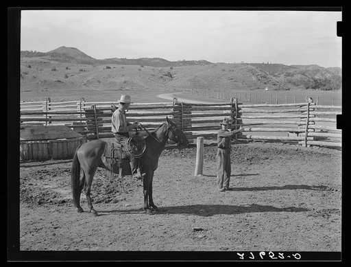 Giving directions to visiting cowhand. Quarter Circle 'U' Ranch, Montana
