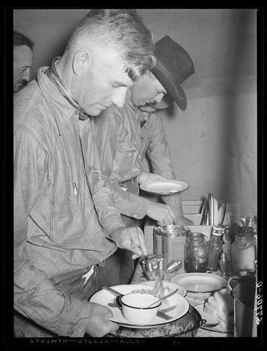 Untitled photo, possibly related to: Cowhand at dinner. Quarter Circle 'U' ranch roundup. Big Horn County, Montana