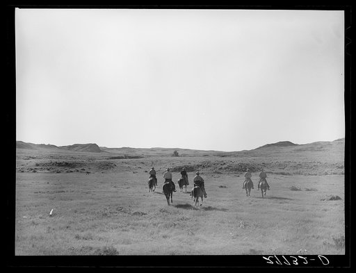 Cowhands riding off for the roundup. William Tonn ranch. Custer County, Montana