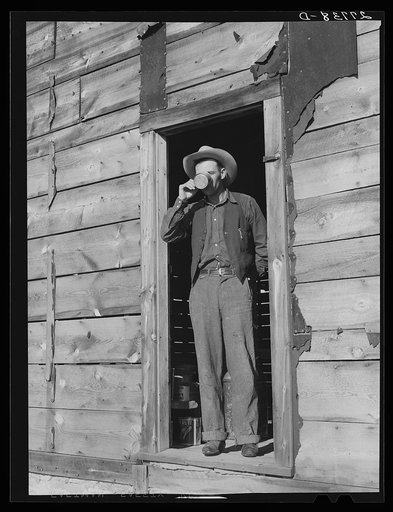 Rancher's son in doorway of abandoned homesteader's shack. William Tonn ranch, Custer County, Montana