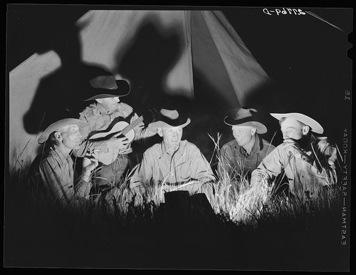 Untitled photo, possibly related to: Cowhands singing after day's work. Quarter Circle 'U' Ranch roundup. Big Horn County, Montana