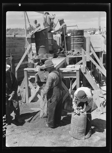 Untitled photo, possibly related to: Filling a bag with poison bait for grasshoppers. Forsyth, Montana