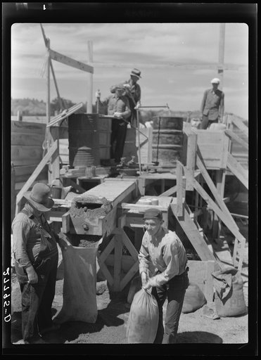 Untitled photo, possibly related to: Filling a bag with poison bait for grasshoppers. Forsyth, Montana