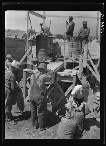 Untitled photo, possibly related to: Filling a bag with poison bait for grasshoppers. Forsyth, Montana