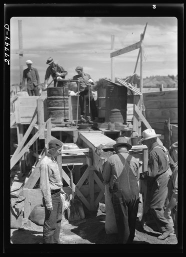 Untitled photo, possibly related to: Filling a bag with poison bait for grasshoppers. Forsyth, Montana