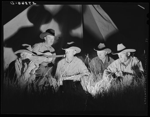 Untitled photo, possibly related to: Cowhands singing after day's work. Quarter Circle 'U' Ranch roundup. Big Horn County, Montana