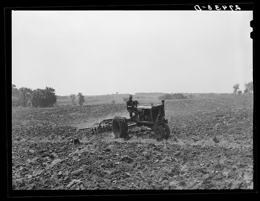 Farmer pulling disc and harrow across plowed field. Kimberley farm, Jasper County, Iowa