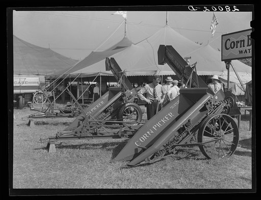 Farmers examine new corn picker at Iowa State Fair. Des Moines, Iowa
