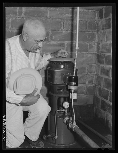 County agent with electric waterpump made possibly by Rural Electrification Adiministration. Grundy County, Iowa