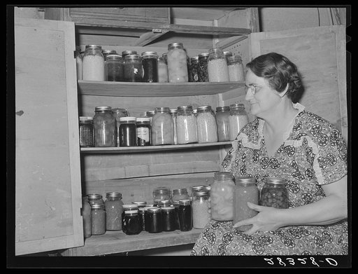 Mrs. Andy Bahain with fruit and vegetables produced on their farm near Kersey, Colorado