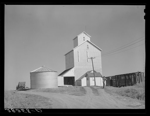 Untitled photo, possibly related to: Grain elevator with steel bin for shelled corn storage under ever-normal granary plan. Marshall County, Iowa