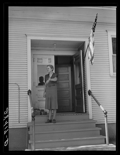 Lois Slinker, teacher of the one room school house. rings bell to end recess period. Grundy County, Iowa