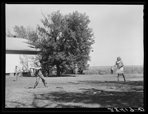 Teacher supervises ball game during recess period. Grundy County, Iowa