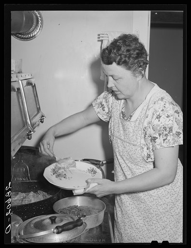 Mrs. Thomas Beede serving dinner resettlement home. Western Slope Farms, Colorado