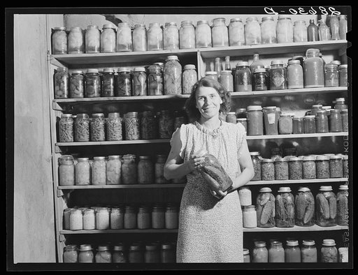 Mrs. H.H. Poland, wife of rehabilitation client, with preserved food. Mesa County, Colorado
