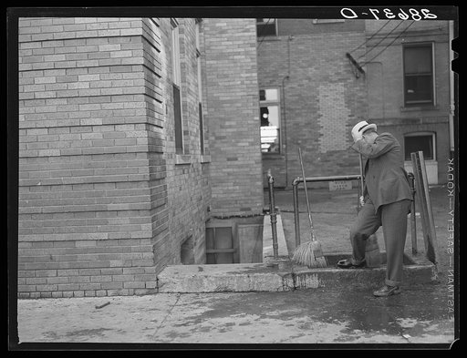 Untitled photo, possibly related to: Cattle buyer cleaning his shoes after trip through the stockyards. Denver, Colorado