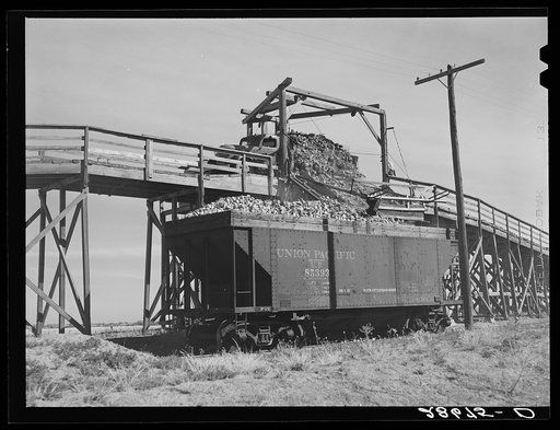 Untitled photo, possibly related to: Loading freight cars for the factory at sugar beet dump. Adams County, Colorado